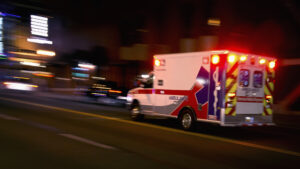 Considerations For Initiating A Personal Injury Claim - An ambulance speeding through traffic at nighttime